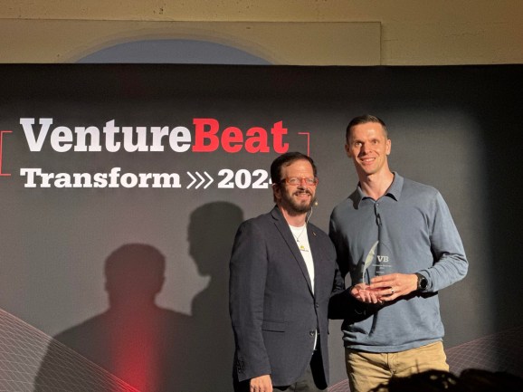 Stewart Rogers presents Clemens Mewald with the Most Likely to Succeed Award at the Innovation Showcase at Transform 2024.